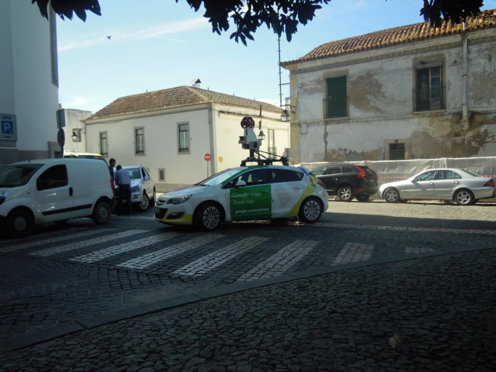 Google Street View camera cars parked in a row, each carrying a roof-mounted multi-lens panoramic camera mast