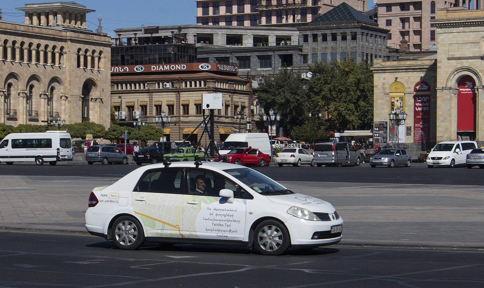 A Yandex panorama capture car with a roof-mounted camera rig parked on Republic Square in Yerevan